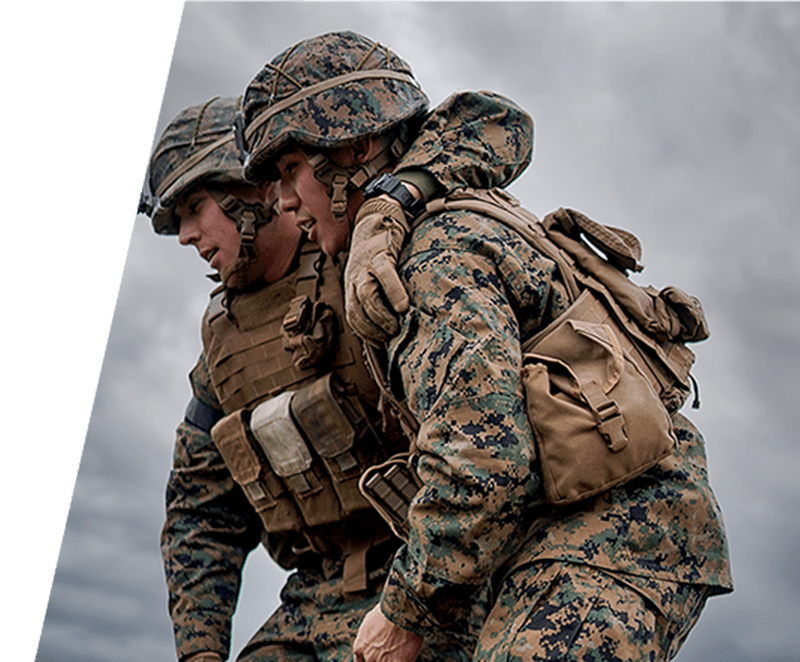 Two soldiers in camouflage uniforms are walking.